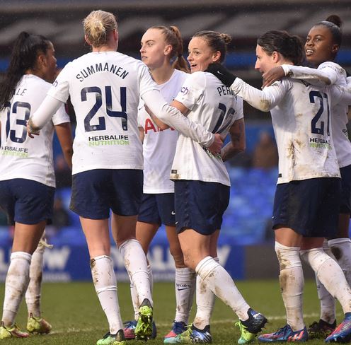 Ria is surrounded by her teammates after scoring. 