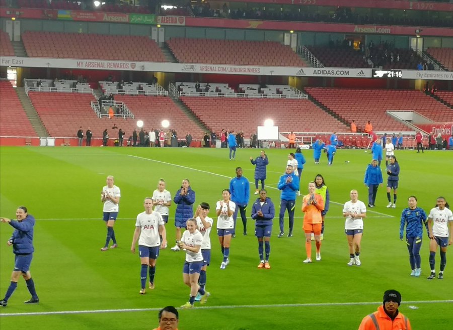 End of the game, Spurs players approach fans.